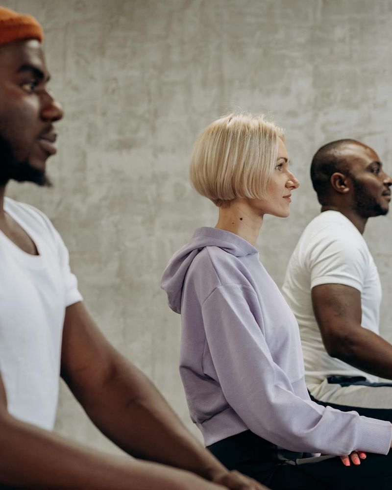 Diverse group of people sitting calmly, showing yoga is inclusive.